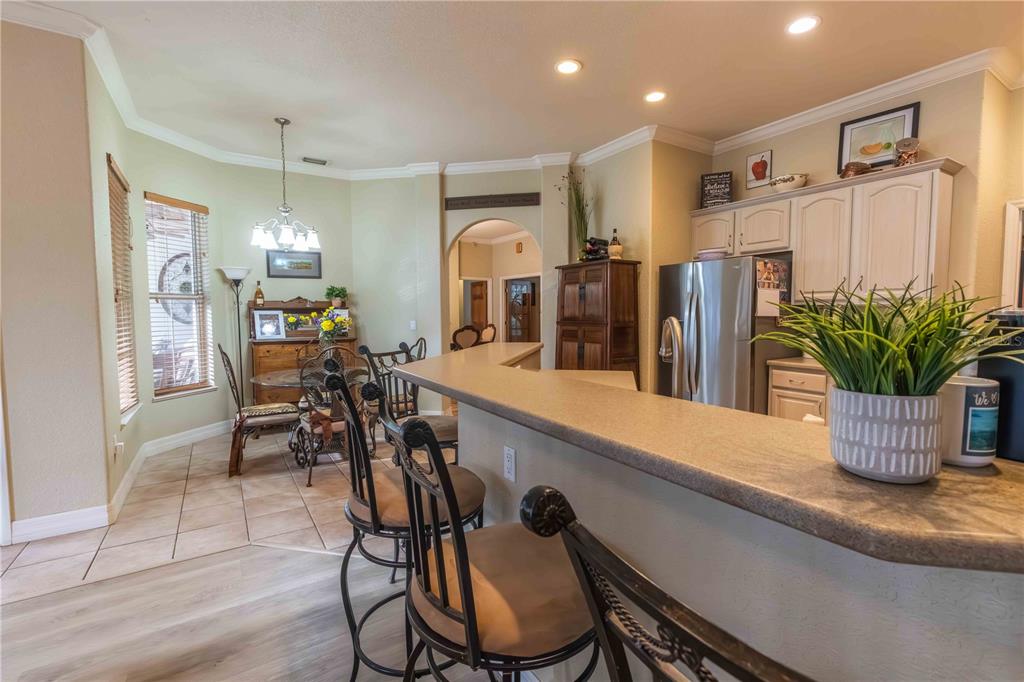2329 South Lake Reedy Boulevard Frostproof, FL 33843 - Photo 35 of 86 a dining room filled chandelier and wooden floor