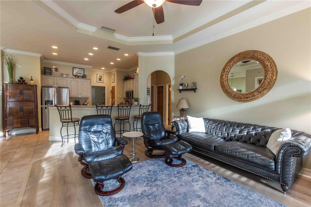 2329 South Lake Reedy Boulevard Frostproof, FL 33843 - Photo 39 of 86 a living room with furniture a fireplace and a chandelier