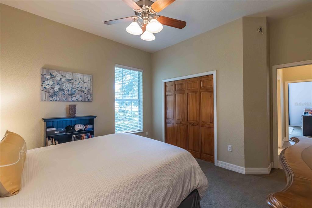 2329 South Lake Reedy Boulevard Frostproof, FL 33843 - Photo 43 of 86 a bedroom with a large bed and a chandelier