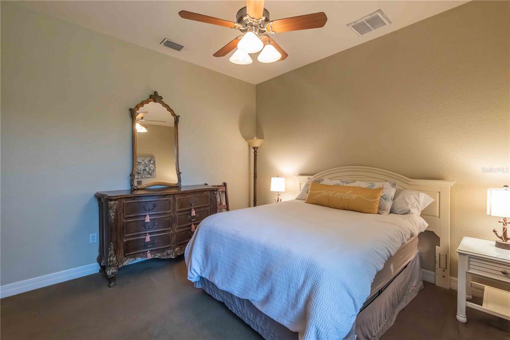 2329 South Lake Reedy Boulevard Frostproof, FL 33843 - Photo 44 of 86 a bedroom with a bed and a chandelier