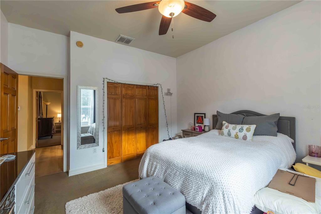 2329 South Lake Reedy Boulevard Frostproof, FL 33843 - Photo 49 of 86 a bedroom with a bed and a chandelier