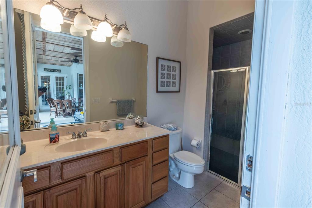 2329 South Lake Reedy Boulevard Frostproof, FL 33843 - Photo 54 of 86 a bathroom with a double vanity sink toilet and a mirror