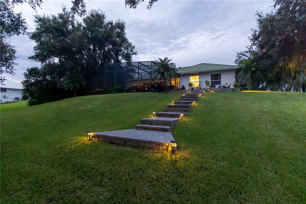 2329 South Lake Reedy Boulevard Frostproof, FL 33843 - Photo 60 of 86 a front view of a house with a yard table and chairs