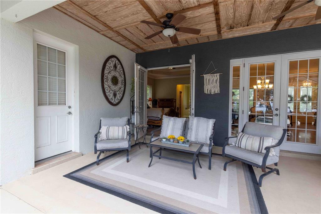 2329 South Lake Reedy Boulevard Frostproof, FL 33843 - Photo 9 of 86 a living room with furniture a clock and a large window