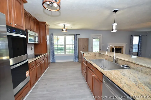 a kitchen with granite countertop a stove and a sink