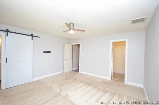 a view of a big room with closet and windows