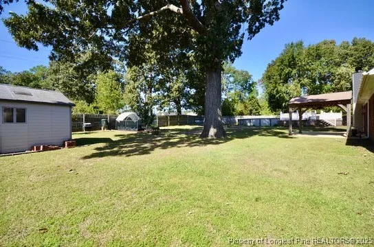a view of a house with pool and a yard