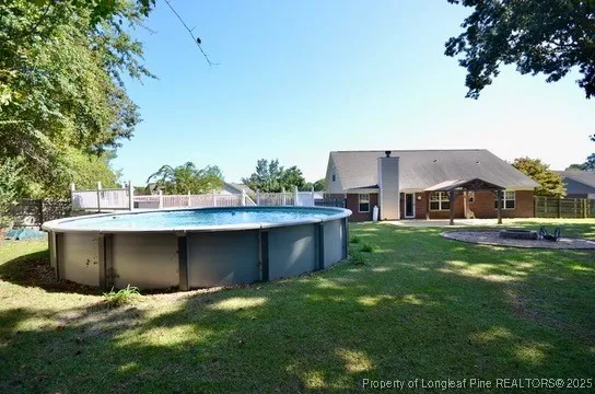 a view of a deck with a floor to ceiling window and wooden fence