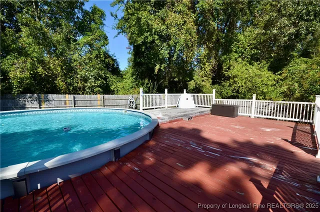 a view of a wooden deck with a table and chairs