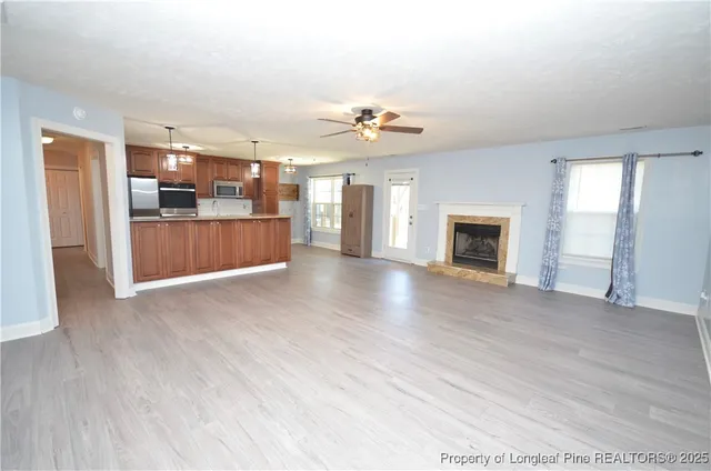 a view of a kitchen with a sink and a fireplace
