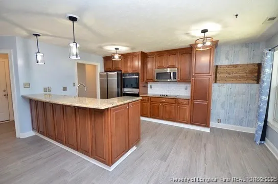 a kitchen with counter top space cabinets and stainless steel appliances