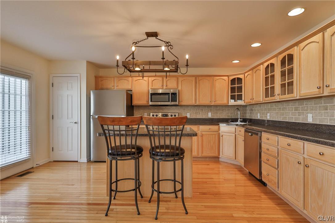 4158 Walter Road Bethlehem, PA 18020 - Photo 9 of 28 a kitchen with stainless steel appliances granite countertop a kitchen island a stove a cabinets a sink and a wooden floors