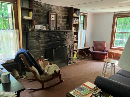 a living room with furniture a window and a fireplace