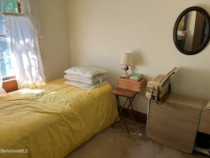 a bedroom with a bed and a mirror