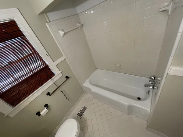 a bathroom with a tub and toilet