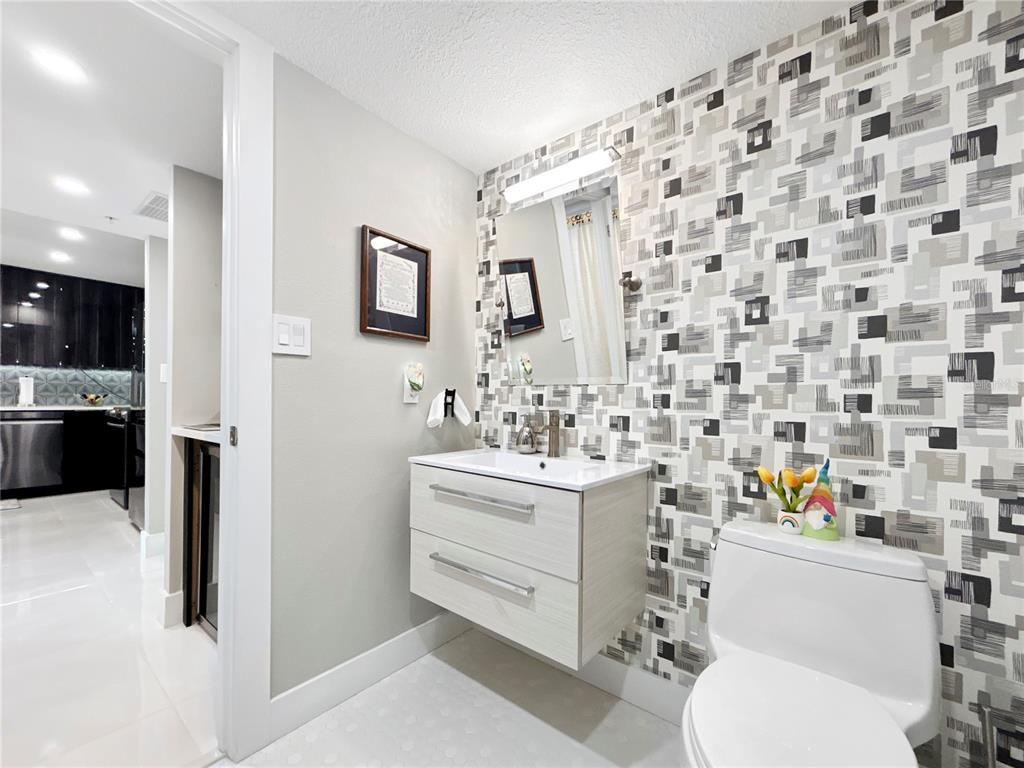 101 South Gulfstream Avenue, Unit 9C Sarasota, FL 34236 - Photo 17 of 24 a bathroom with a sink toilet vanity and shower