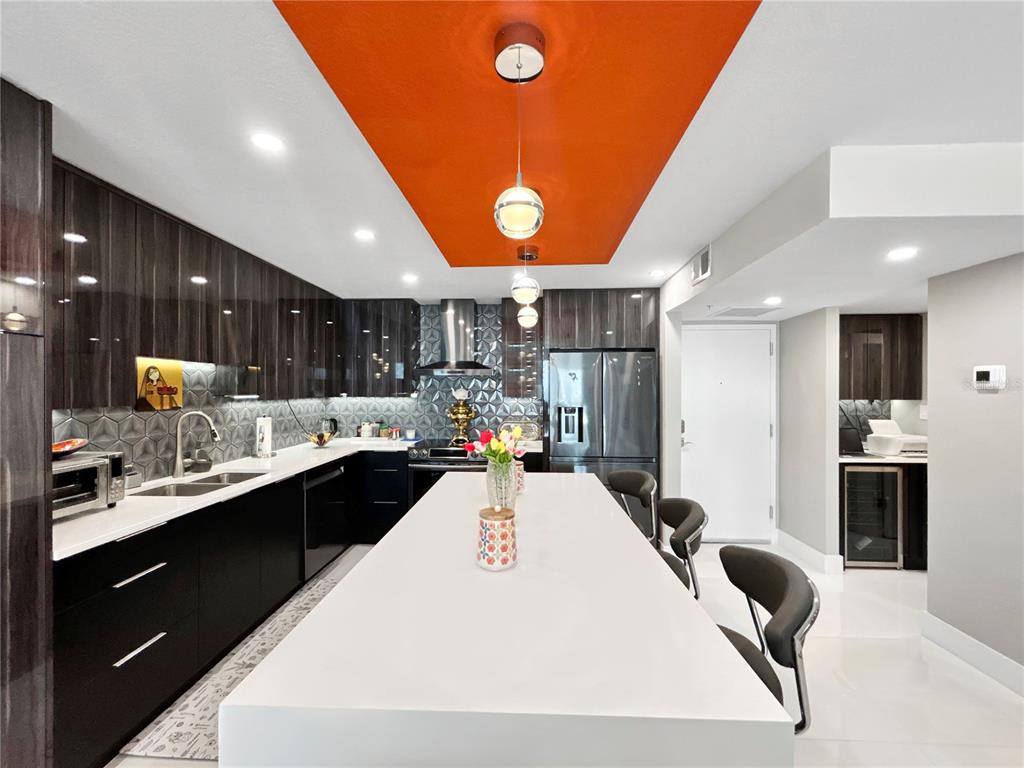 101 South Gulfstream Avenue, Unit 9C Sarasota, FL 34236 - Photo 6 of 24 a large white kitchen with a large window a sink and stainless steel appliances