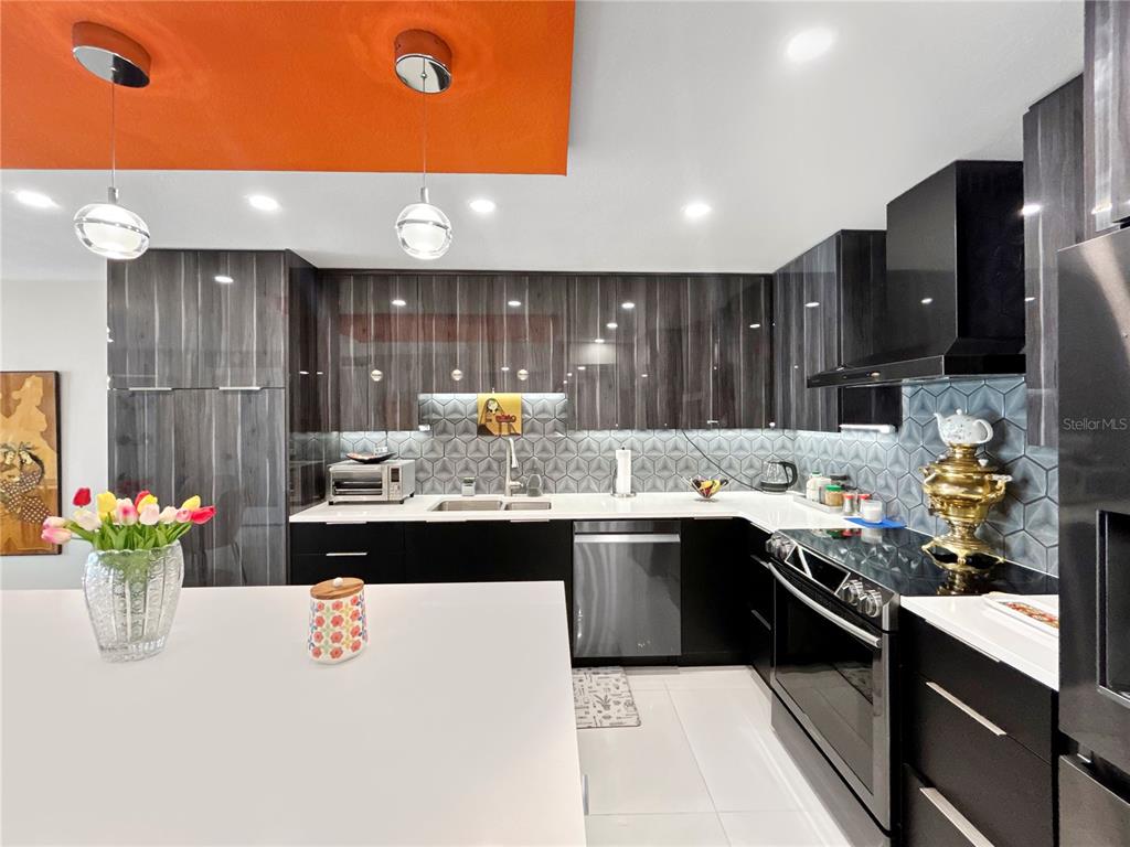 101 South Gulfstream Avenue, Unit 9C Sarasota, FL 34236 - Photo 7 of 24 a kitchen with kitchen island a sink appliances and cabinets