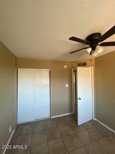 2311 West Glenrosa Avenue, Unit 1 Phoenix, AZ 85015 - Photo 2 of 12 an empty room with a mirror and a ceiling fan