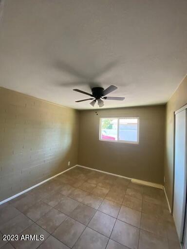 2311 West Glenrosa Avenue, Unit 1 Phoenix, AZ 85015 - Photo 3 of 12 an empty room with windows and ceiling fan