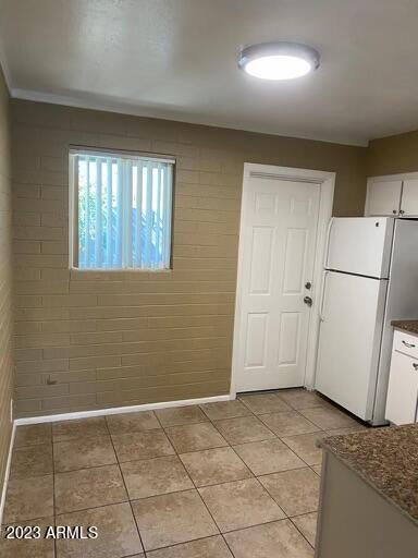 2311 West Glenrosa Avenue, Unit 1 Phoenix, AZ 85015 - Photo 6 of 12 a view of a kitchen with a fridge and wooden floor