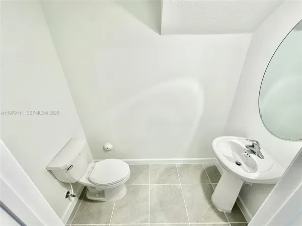 a bathroom with a toilet and a mirror
