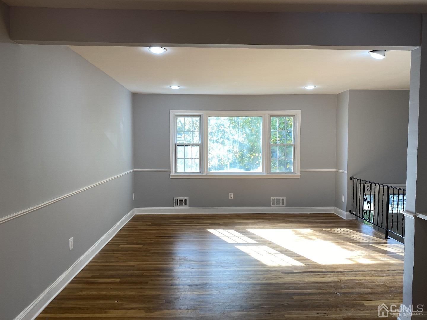34 Hillsdale Road Edison, NJ 08820 - Photo 3 of 6 a view of empty room with wooden floor and fan