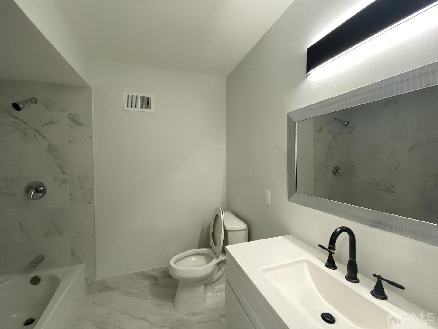 34 Hillsdale Road Edison, NJ 08820 - Photo 4 of 6 a bathroom with a sink a toilet and shower