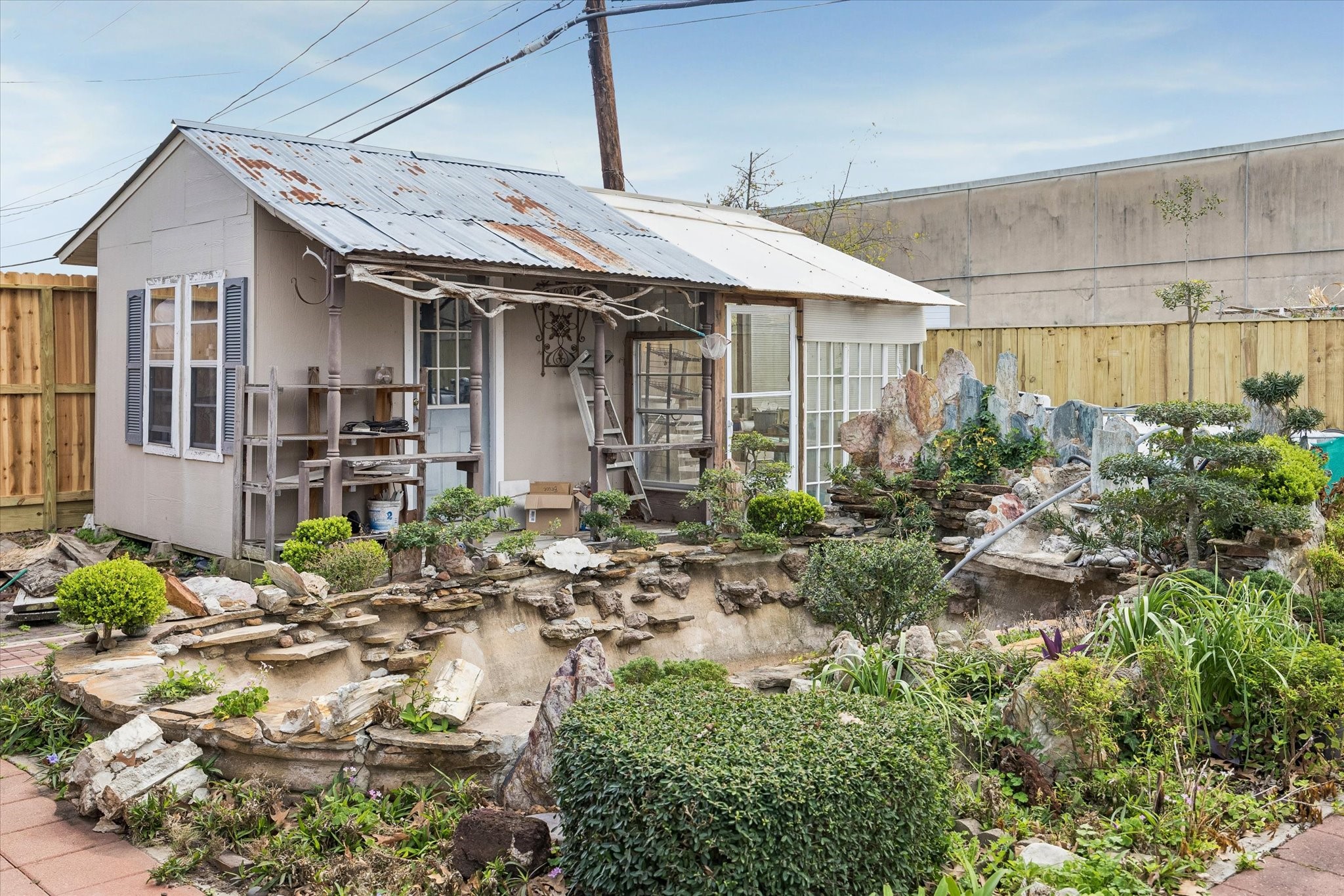 6529 Rolla Street Houston, TX 77055 - Photo 28 of 28 The koi pond is ready for new fish friends, and the shed stays for additional storage.