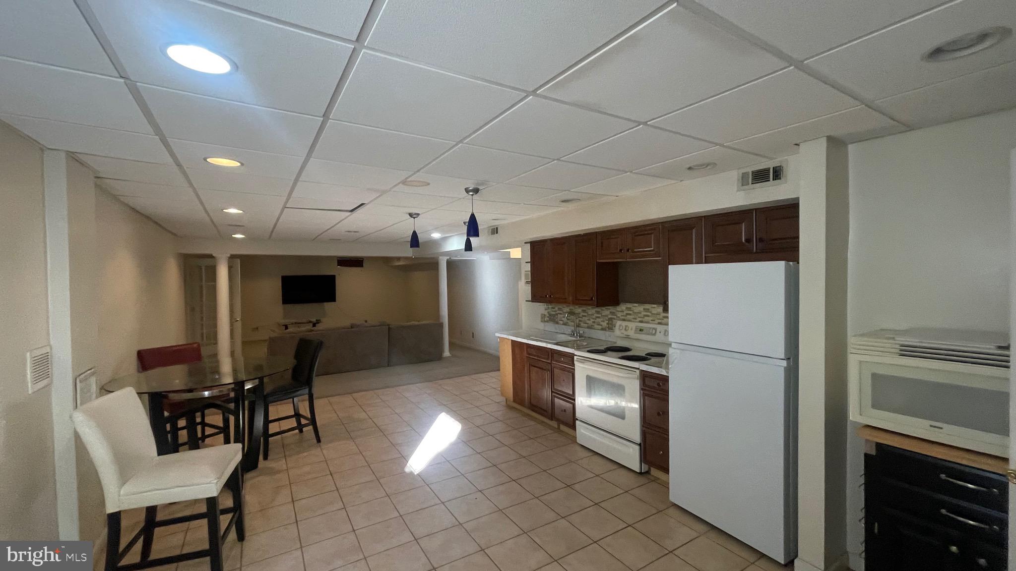 14764 Courtlandt Heights Road Woodbridge, VA 22193 - Photo 12 of 17 a kitchen with furniture and a refrigerator
