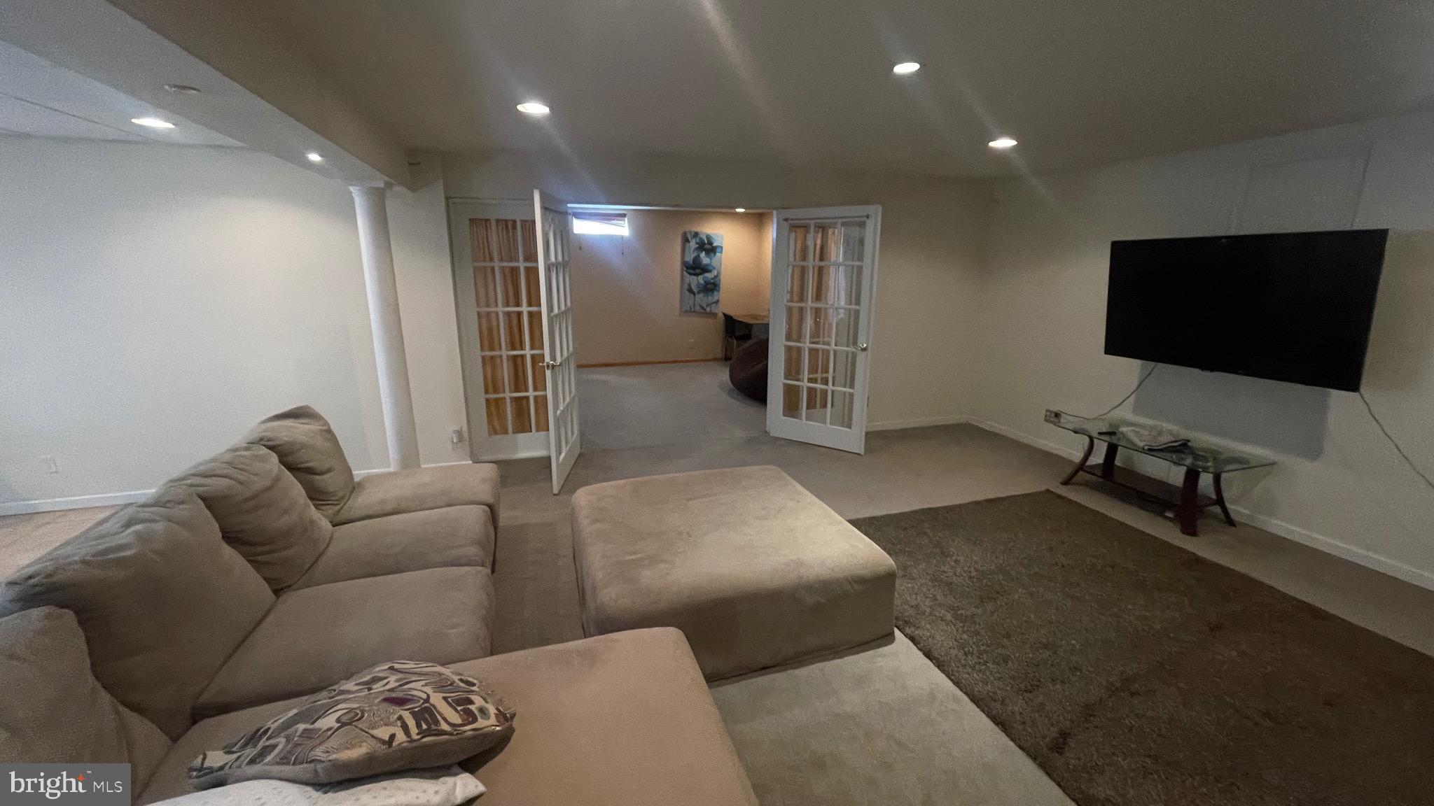 14764 Courtlandt Heights Road Woodbridge, VA 22193 - Photo 14 of 17 a living room with furniture and a flat screen tv