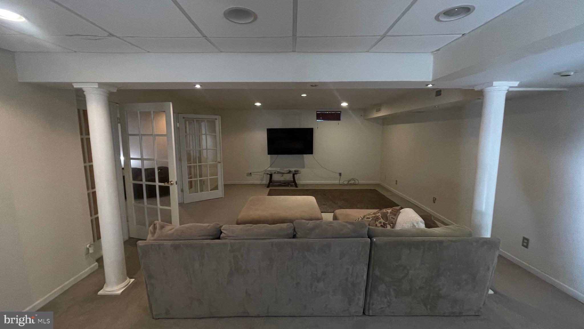14764 Courtlandt Heights Road Woodbridge, VA 22193 - Photo 10 of 17 a living room with furniture and a flat screen tv