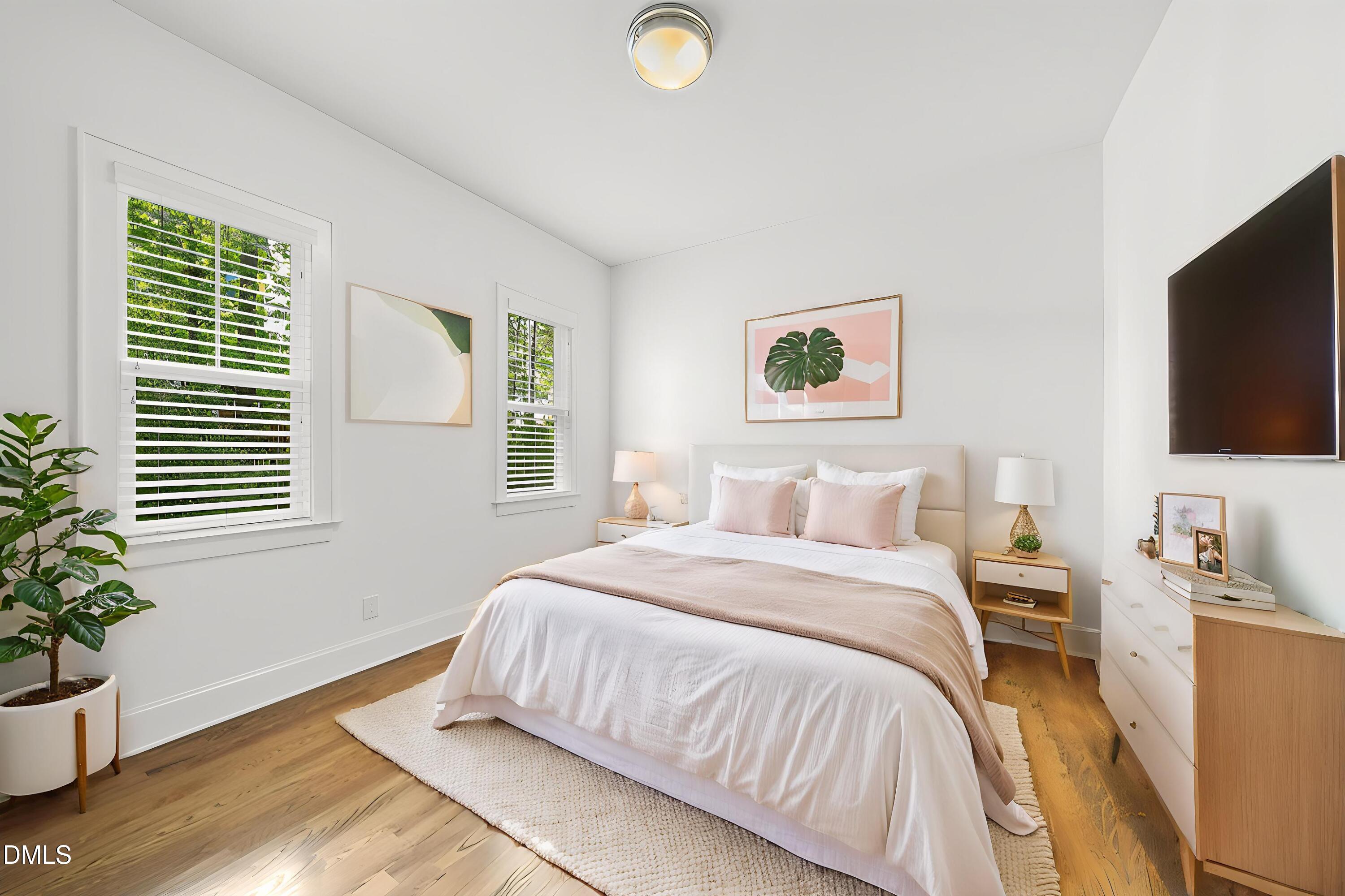 5109 Wainscott Way Raleigh, NC 27612 - Photo 22 of 52 a bedroom with a bed and a flat screen tv