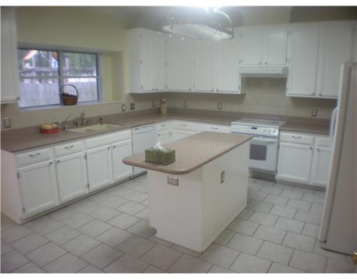 5113 Kings Court Corpus Christi, TX 78413 - Photo 2 of 10 a kitchen with a sink stove and cabinets