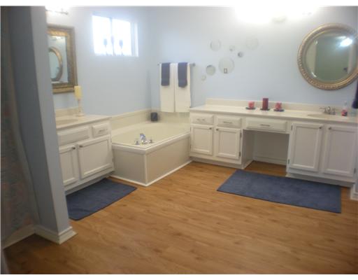5113 Kings Court Corpus Christi, TX 78413 - Photo 7 of 10 a bathroom with a sink double vanity and a mirror