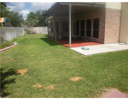 5113 Kings Court Corpus Christi, TX 78413 - Photo 10 of 10 a view of a backyard with large trees and plants