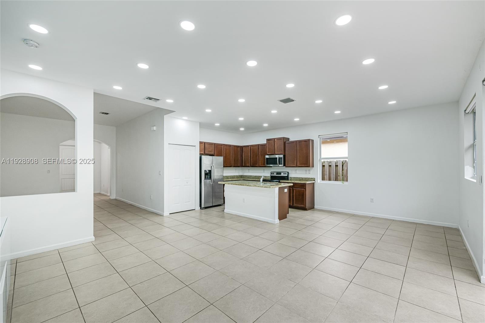 11863 Southwest 253rd Terrace Homestead, FL 33032 - Photo 11 of 30 a view of kitchen with stainless steel appliances kitchen island granite countertop a refrigerator and a stove top oven