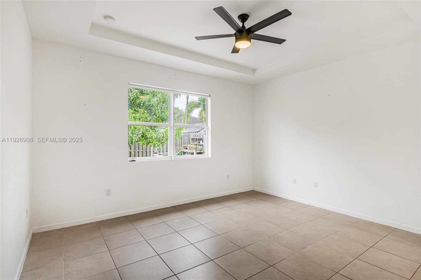 11863 Southwest 253rd Terrace Homestead, FL 33032 - Photo 13 of 30 an empty room with a window and a fan