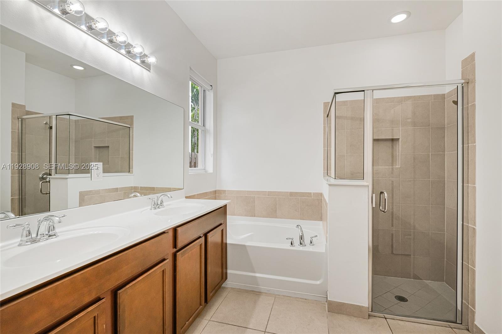 11863 Southwest 253rd Terrace Homestead, FL 33032 - Photo 21 of 30 a bathroom with a granite countertop sink mirror and shower