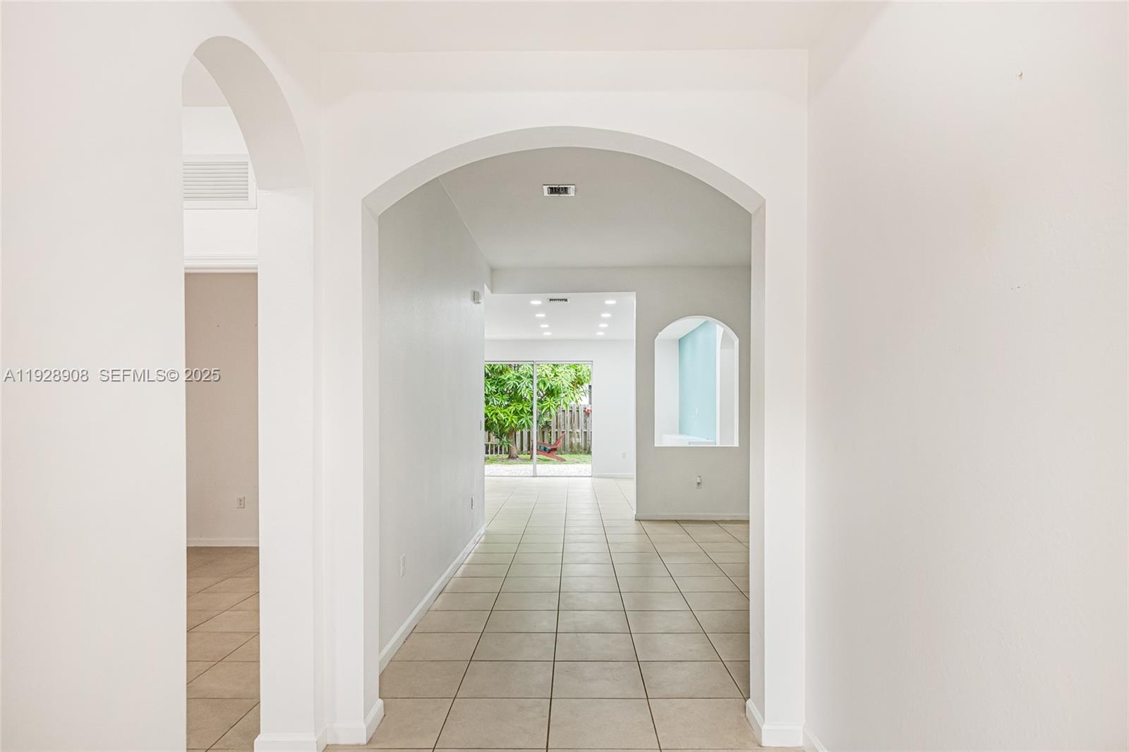 11863 Southwest 253rd Terrace Homestead, FL 33032 - Photo 24 of 30 a view of a hallway with wooden floor and a mirror