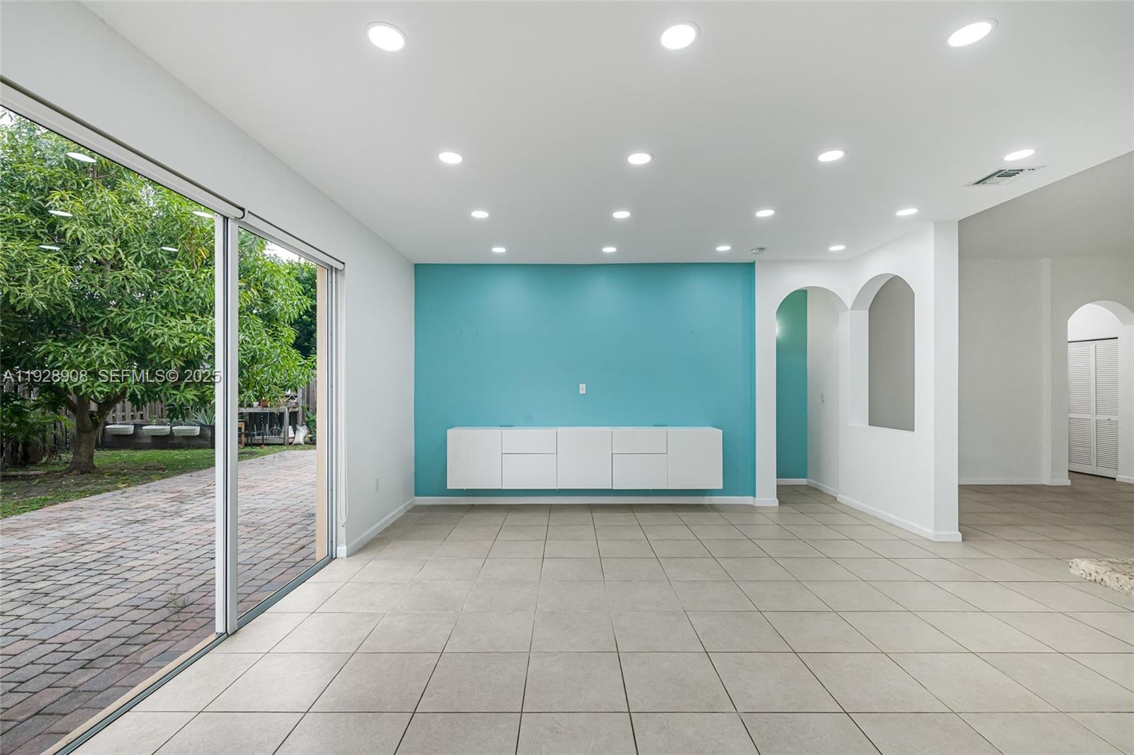 11863 Southwest 253rd Terrace Homestead, FL 33032 - Photo 8 of 30 a view of an empty room with wooden floor and a window