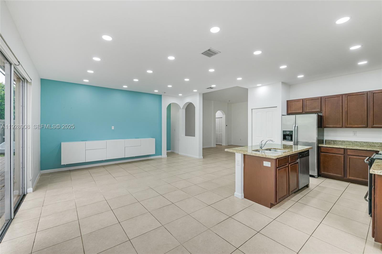 11863 Southwest 253rd Terrace Homestead, FL 33032 - Photo 10 of 30 a open kitchen with stainless steel appliances granite countertop a refrigerator and a stove