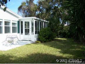 403 Portside Lane Edgewater, FL 32141 - Photo 4 of 12 a view of a house with backyard and sitting area