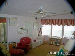 403 Portside Lane Edgewater, FL 32141 - Photo 9 of 12 a living room with furniture a window and a chandelier