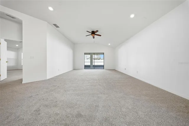 a view of a room with stairs and a ceiling fan