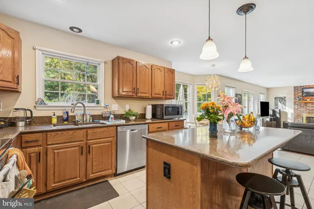 a kitchen with stainless steel appliances granite countertop a sink and cabinets