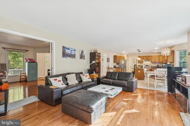 a living room with furniture a piano and a fireplace