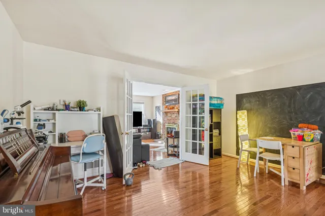 a view of a hallway with wooden floor and entryway