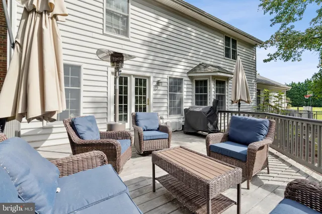 a view of a house with swimming pool and sitting area