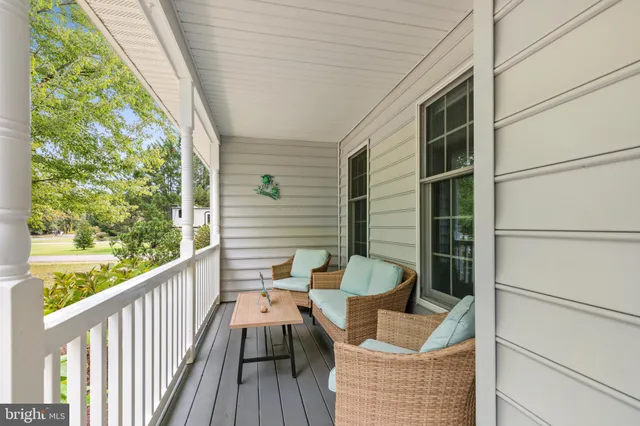 a balcony with wooden floor and furniture